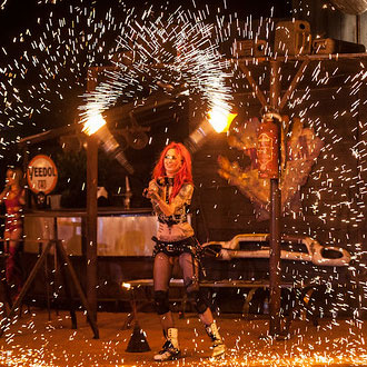 Shelly d’Inferno performing her flaming poi act.